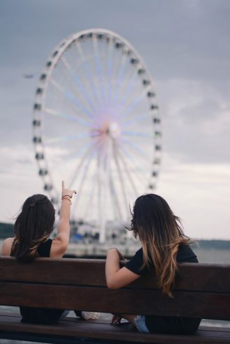 women admiring a Ferris wheel 