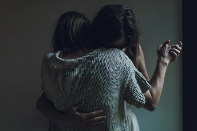women hugging each other 