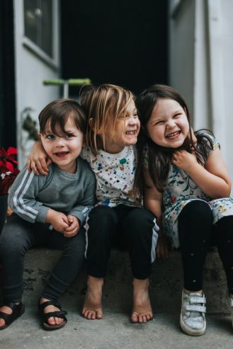 three kids smiling 