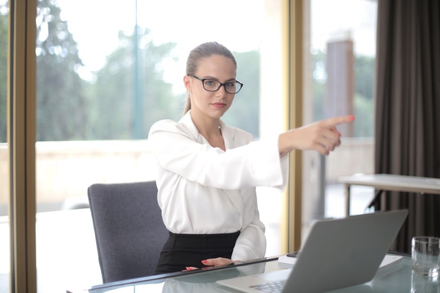 woman pointing away in the office