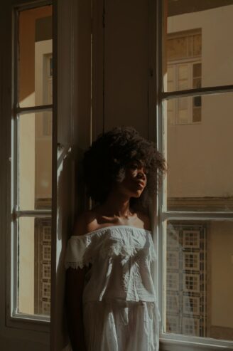 black woman standing near the window