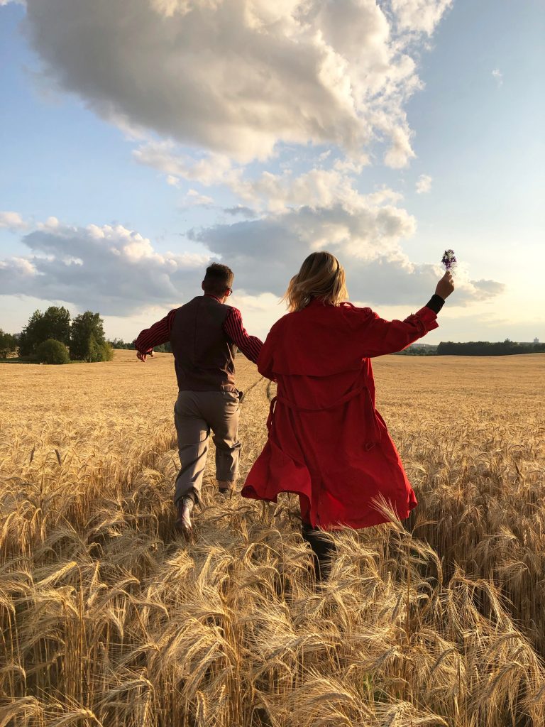 a couple running in a field