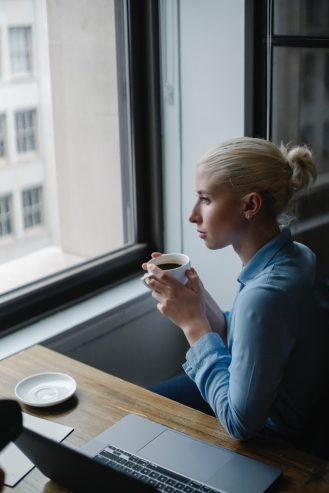 woman drinking coffee in modern office