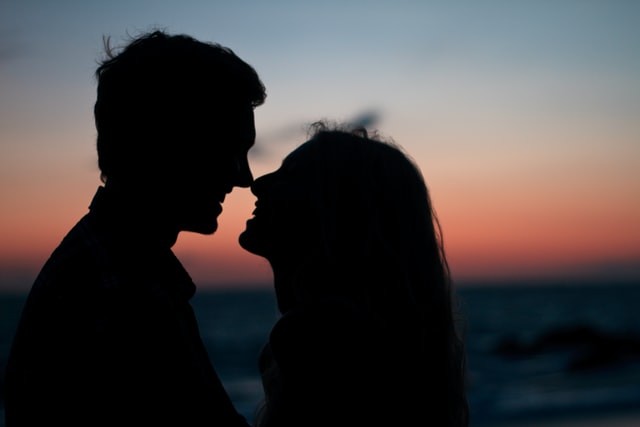 silhouette of a couple smiling with each other 