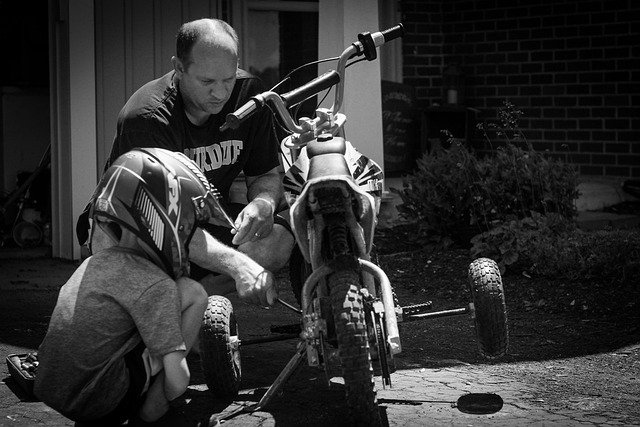 dad with his son fixing bike