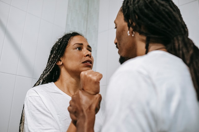 anxious black couple arguing in bathroom