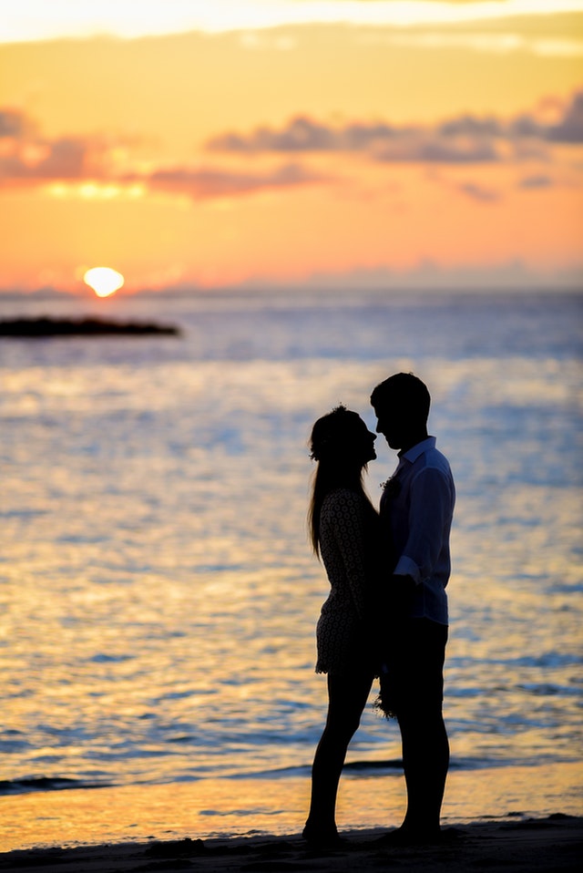 silhouette of a couple on a seashore 
