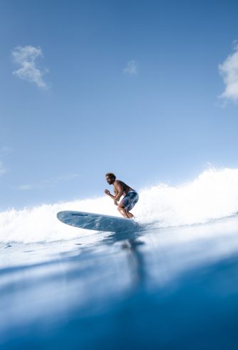 man surfing on blue sea water 
