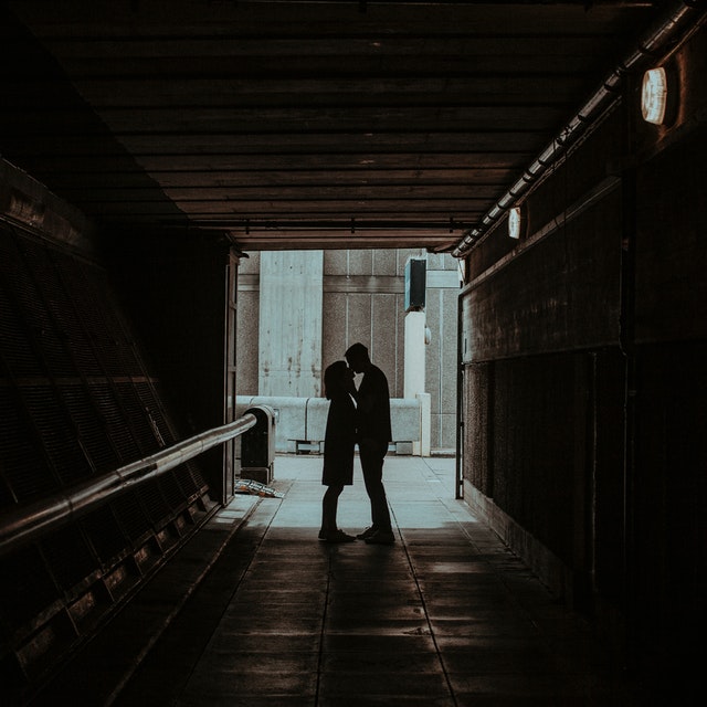 couple kissing in a hallway
