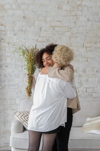 multiracial women hugging each other 