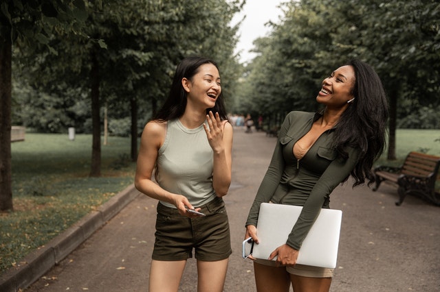 multiethnic women talking and laughing in the green park 