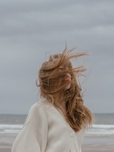 woman with windy hair on the seashore 