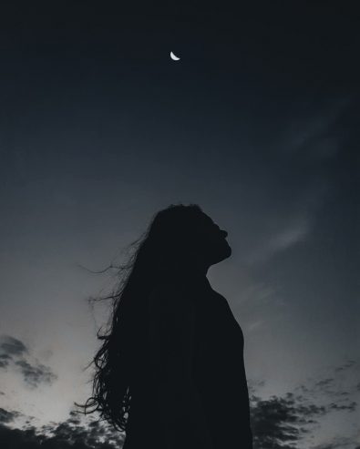 lonely woman under night sky 