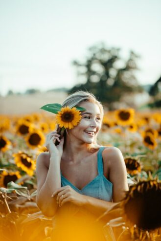 woman with sunflower on her ear