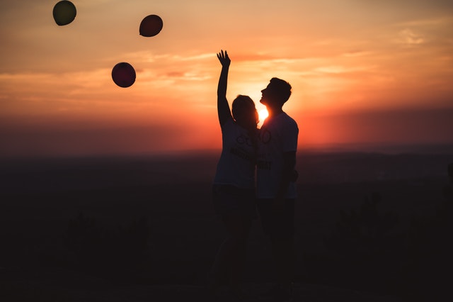 silhouette photo of a couple standing outdoors
